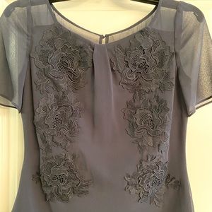 Blouse with rose lace appliqués